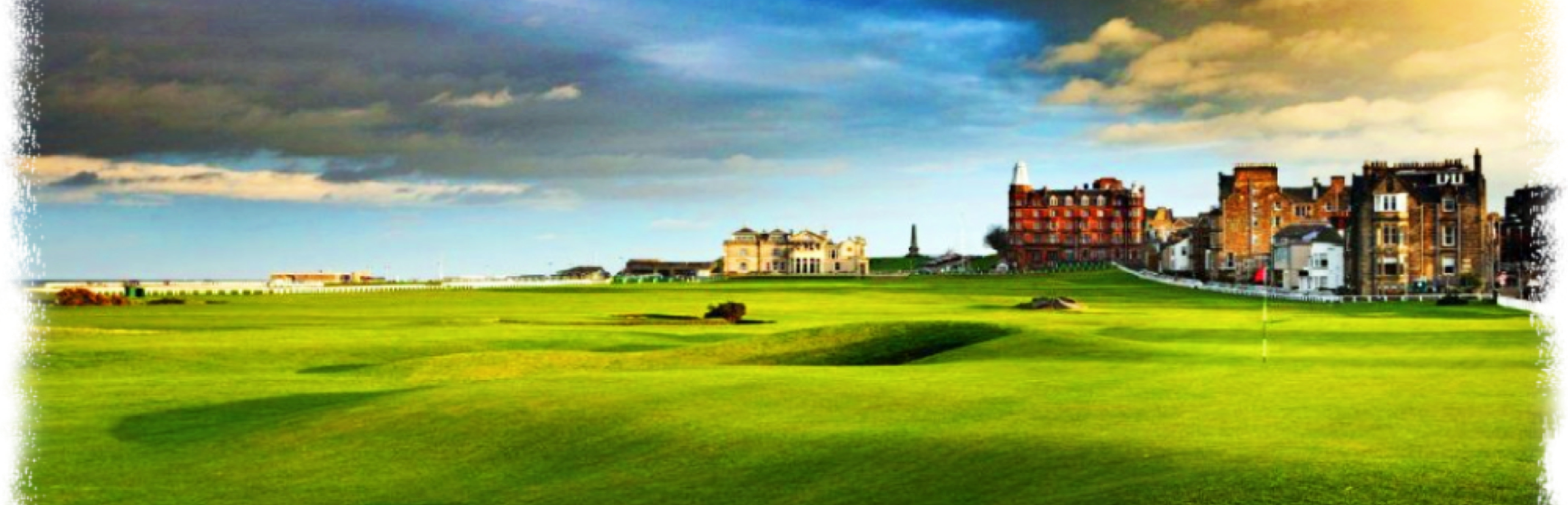 A wide view of a green golf course with a historic building and cloudy sky in the background.